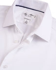 White dress shirt with collar and label detail on a white background
