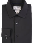 Folded black dress shirt with a label on a white background