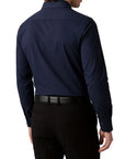 Navy blue dress shirt worn by a person on a white background