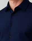 Navy blue button-up shirt on a gray background