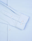 Light blue dress shirt with folded collar and cuffs on a matching background