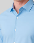 Light blue shirt with collar and buttons on a neutral background