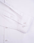 Close-up of a white shirt with buttons on a light gray background