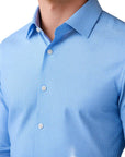 Blue checkered shirt worn by a person on a gray background