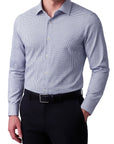 Man wearing a blue checkered dress shirt and black pants on a white background