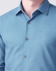 Close-up of a blue checkered shirt with a plain background