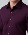 Close-up of a purple button-up shirt on a gray background