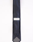 Navy blue tie with a pattern on a white background, featuring the Bill Blass label.