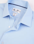 Light blue dress shirt with a brand label on a white background