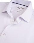 White dress shirt with a collar detail and brand label on a white background