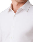 Close-up of a white dress shirt with a collar on a white background