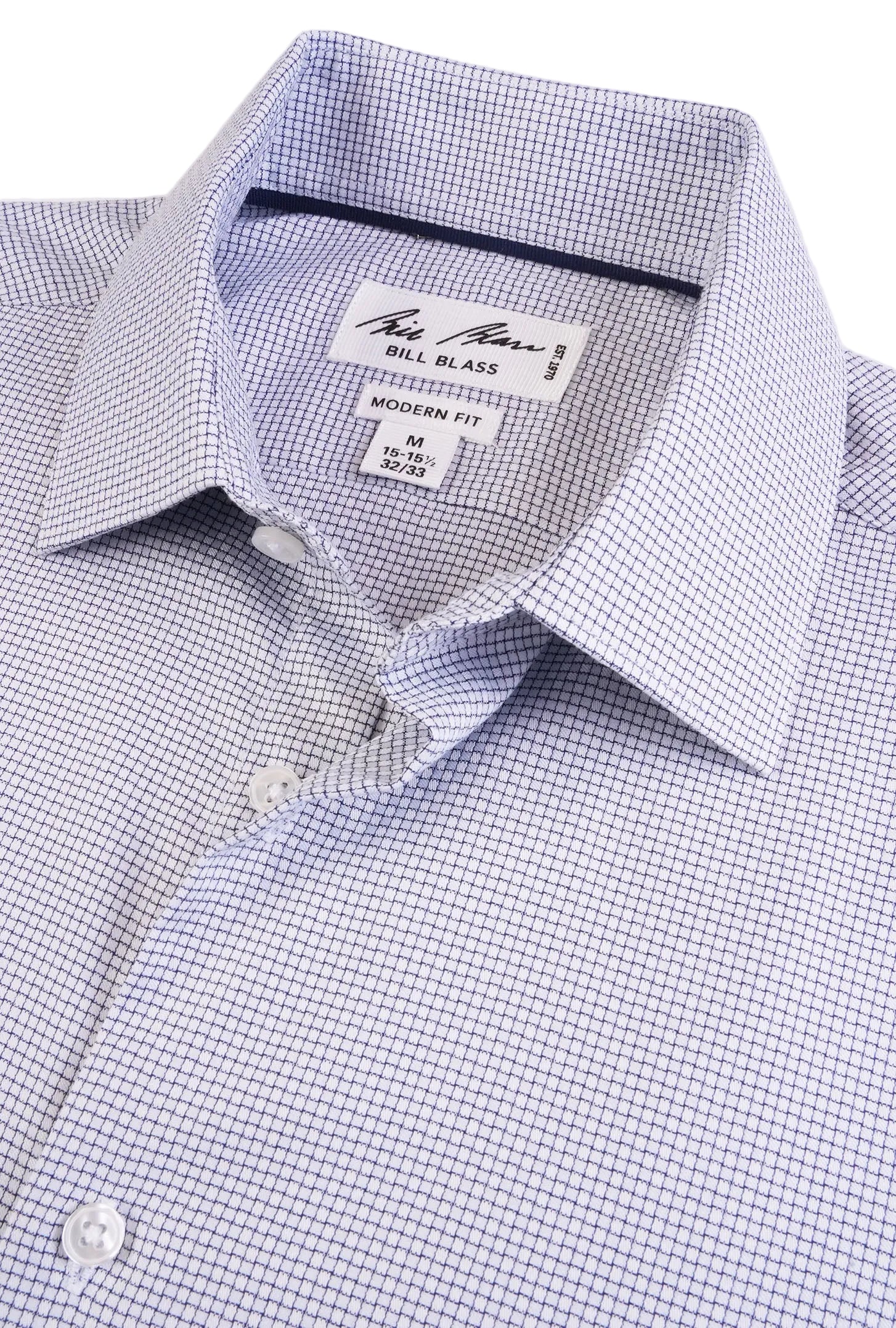 Close-up of a blue checkered dress shirt with 'Bill Blass' label on a light gray background