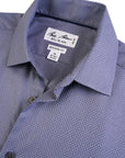 Close-up of a blue checkered dress shirt with a brand label on a white background
