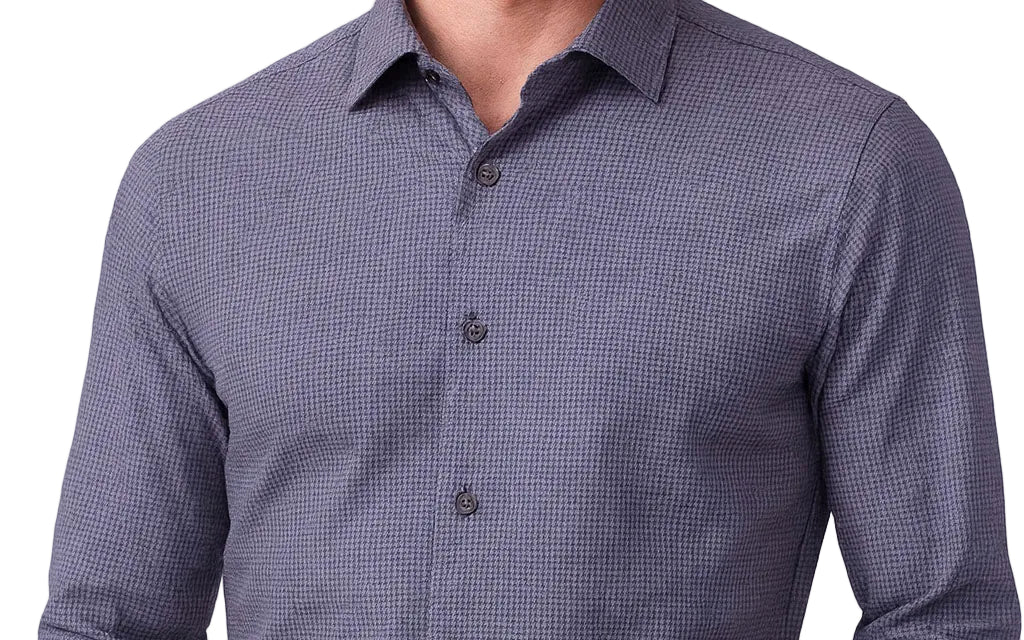 Blue checkered shirt worn by a person on a white background