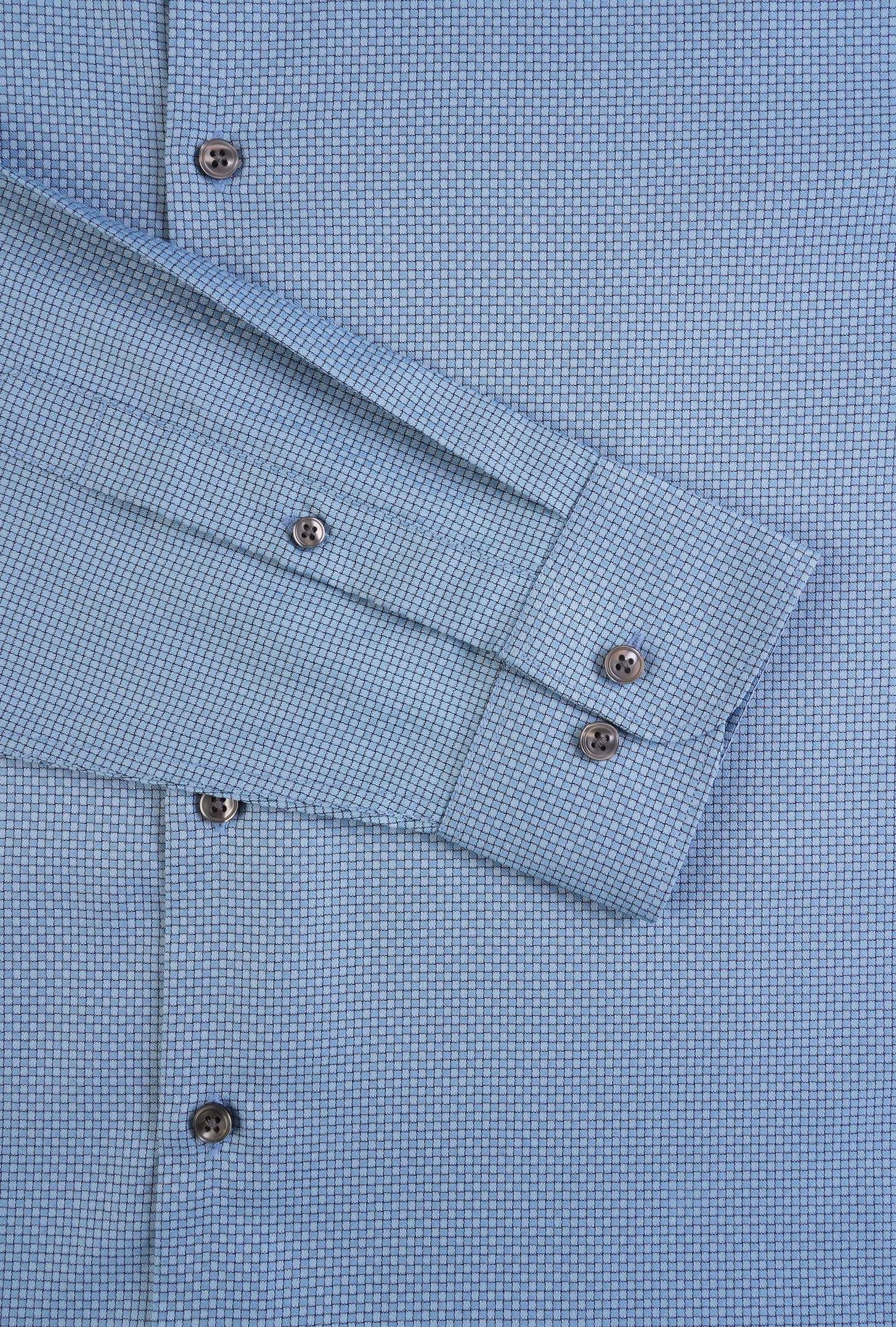 Close-up of a blue checkered shirt with cuff details