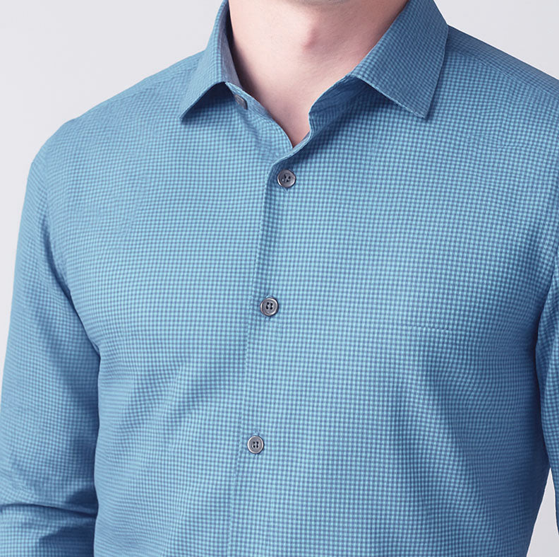 Close-up of a blue checkered shirt with a plain background