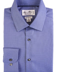 Folded blue dress shirt with a pattern on a white background
