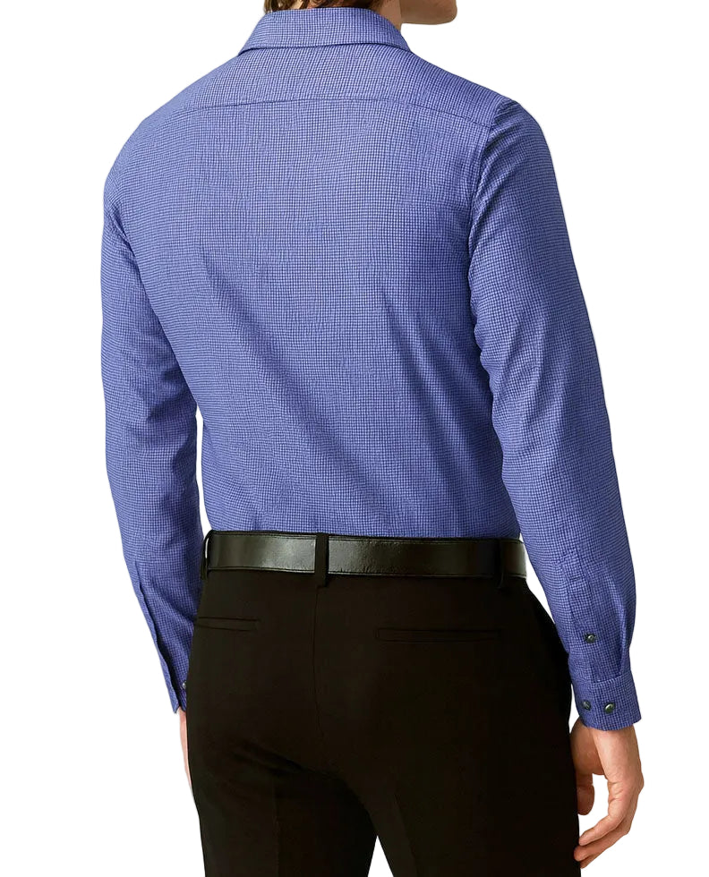 Person wearing a blue checkered shirt and black pants on a light gray background