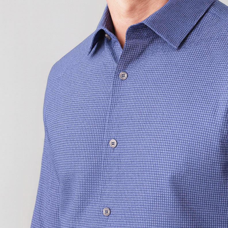 Close-up of a blue checkered shirt on a light gray background