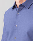 Close-up of a blue checkered shirt on a light gray background