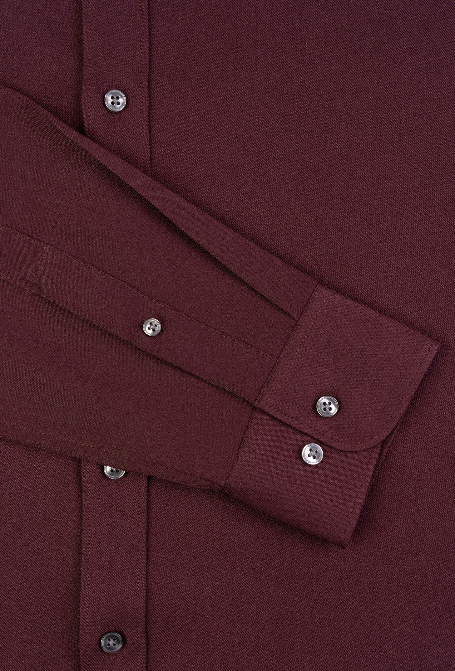 Close-up of a burgundy shirt with buttons and collar details.