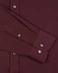 Close-up of a burgundy shirt with buttons and collar details.