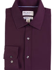 Folded purple dress shirt with 'Bill Blass' label on a white background