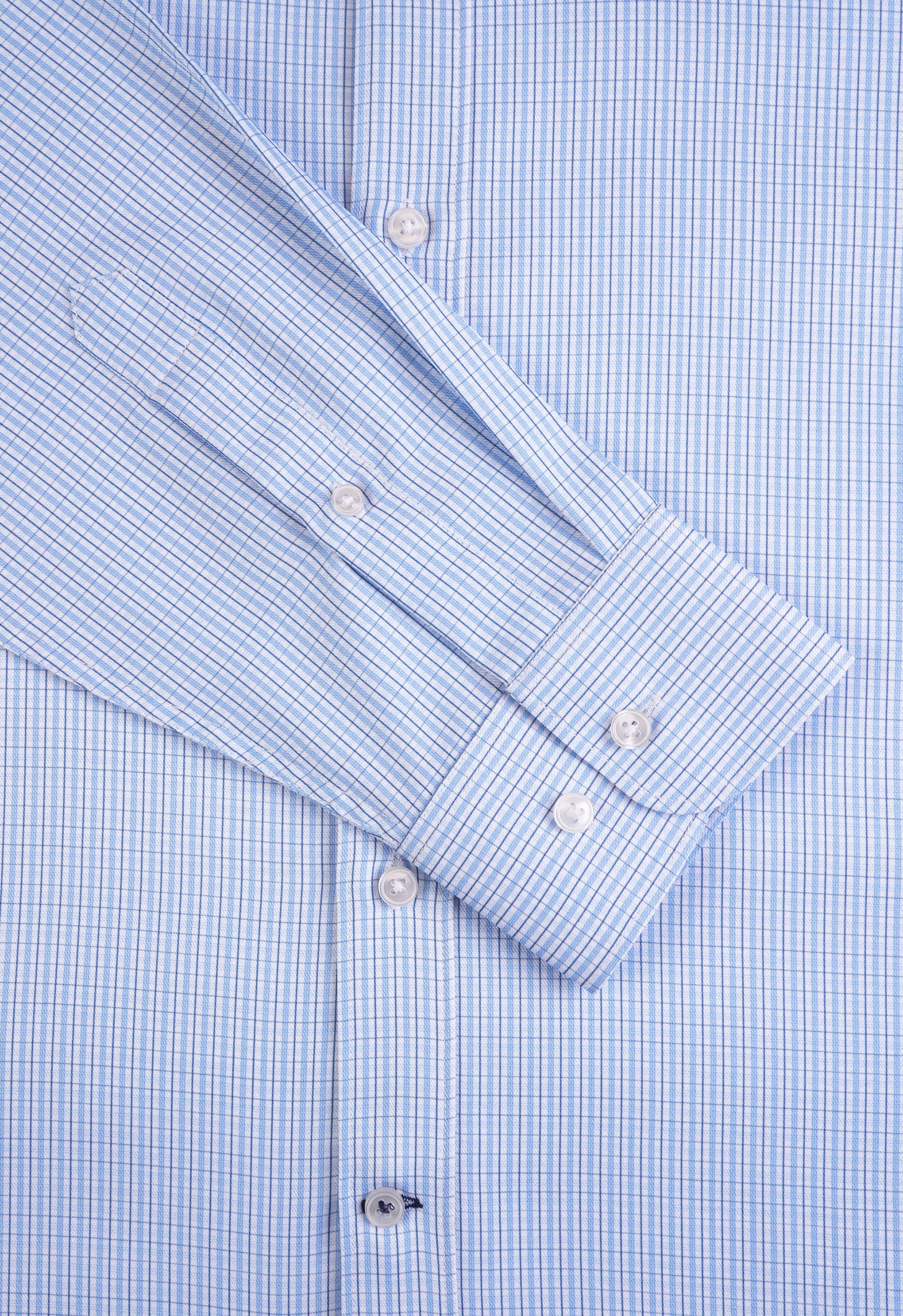 Close-up of a blue checkered shirt with folded sleeves