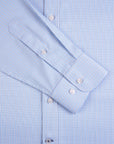 Close-up of a blue checkered shirt with folded sleeves