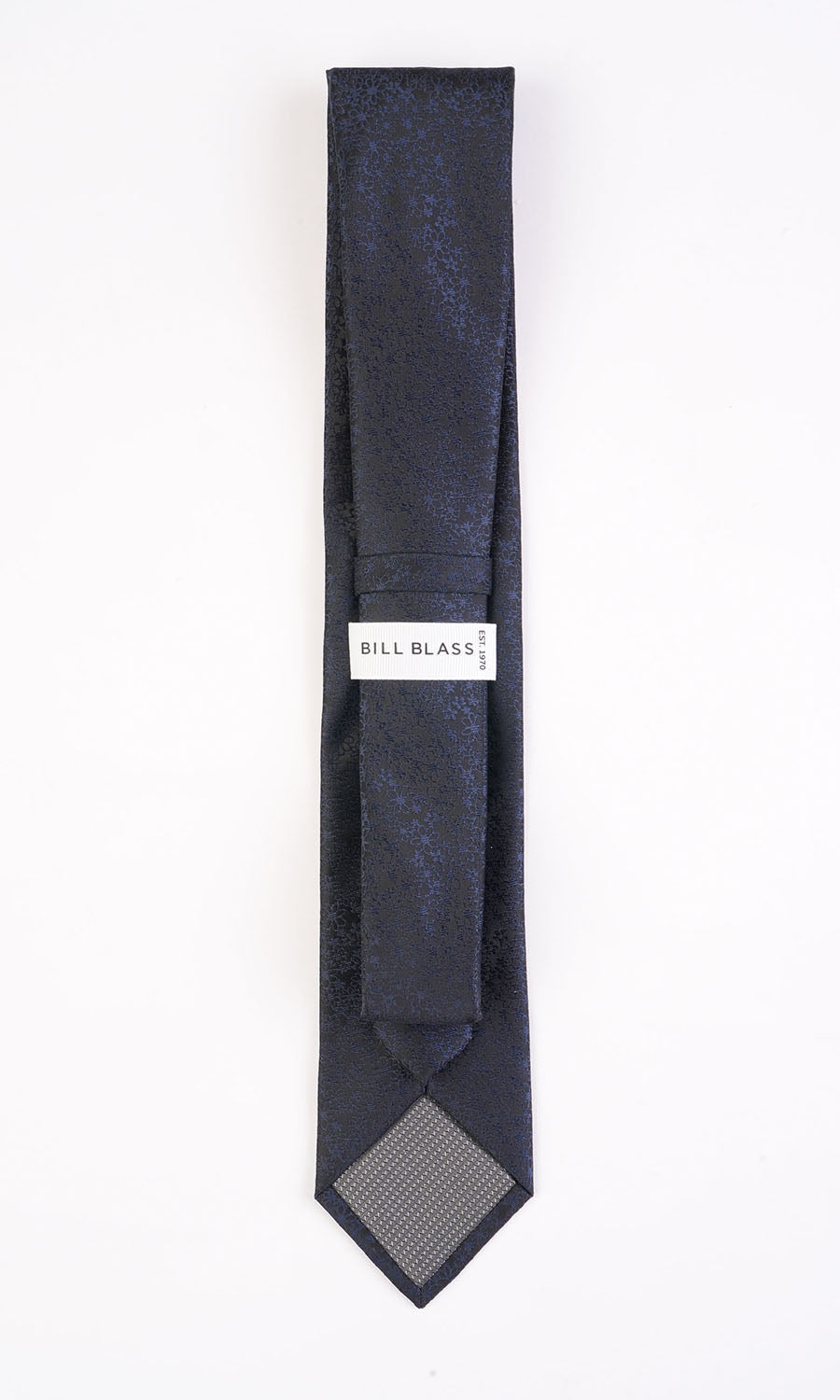 Navy blue tie with a pattern on a white background, featuring the Bill Blass label.