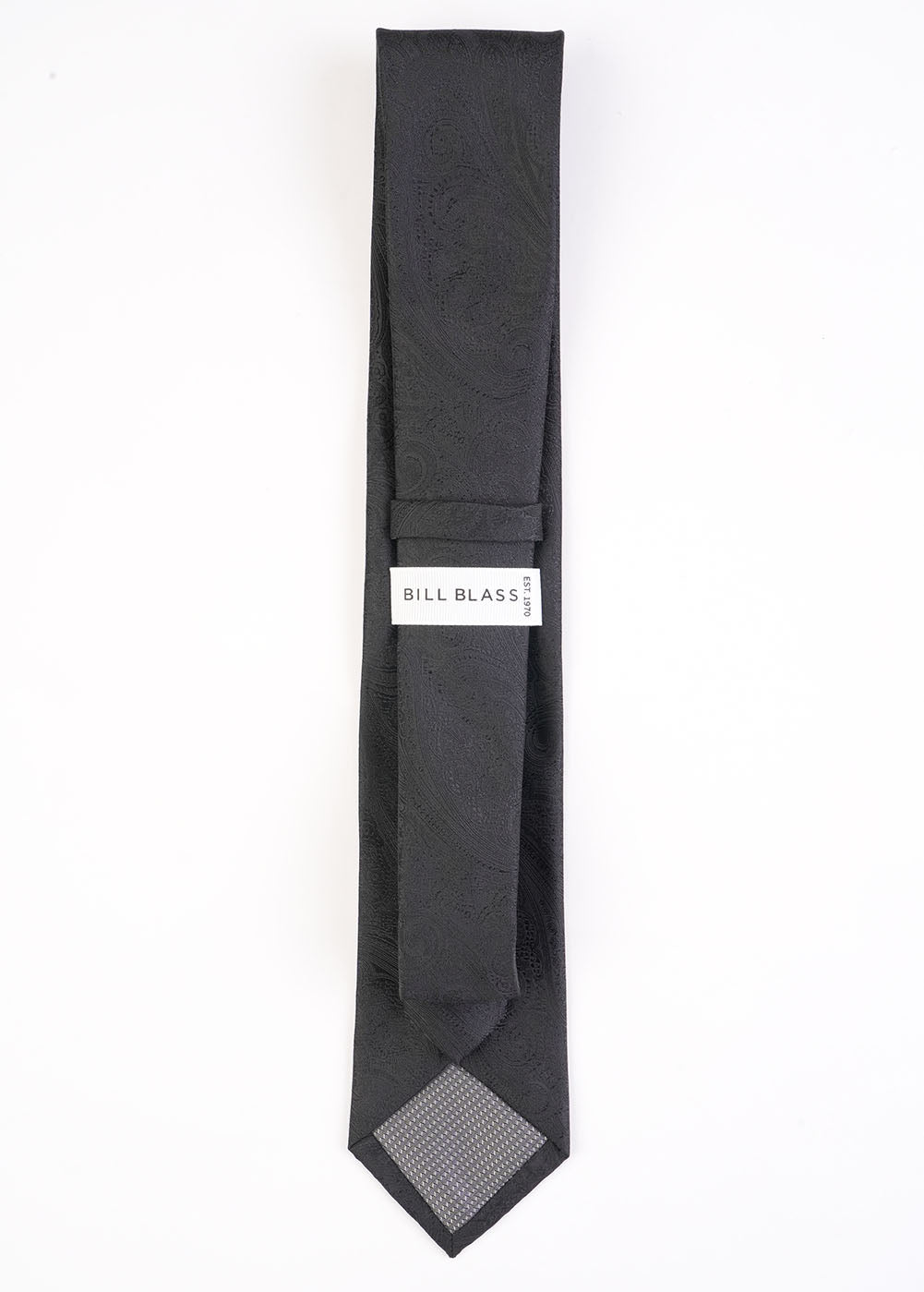 Black tie with a patterned end and 'Bill Blass' label on a white background