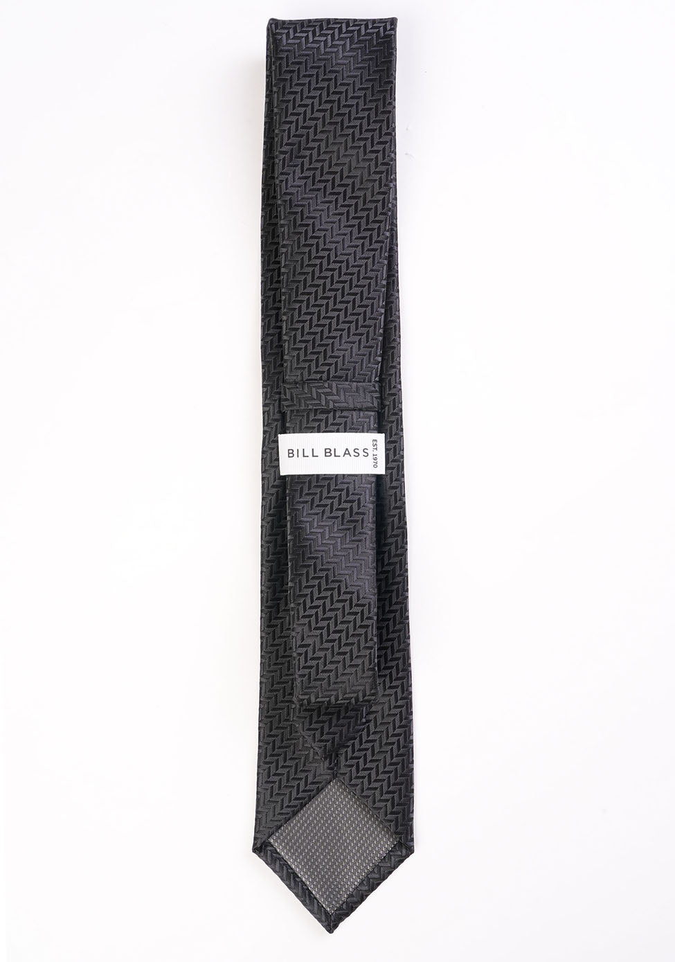Black patterned tie with 'Bill Blass' label on a white background